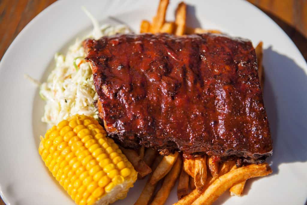 Plate of ribs with corn and coleslaw
